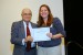 Dr. Nagib Callaos, General Chair, giving Dr. Jennifer L. Styron the best paper award certificate of the session "Applications of ICT in Education and Training". The title of the awarded paper is "Perceptions of Electronic Health Records in Mississippi."
